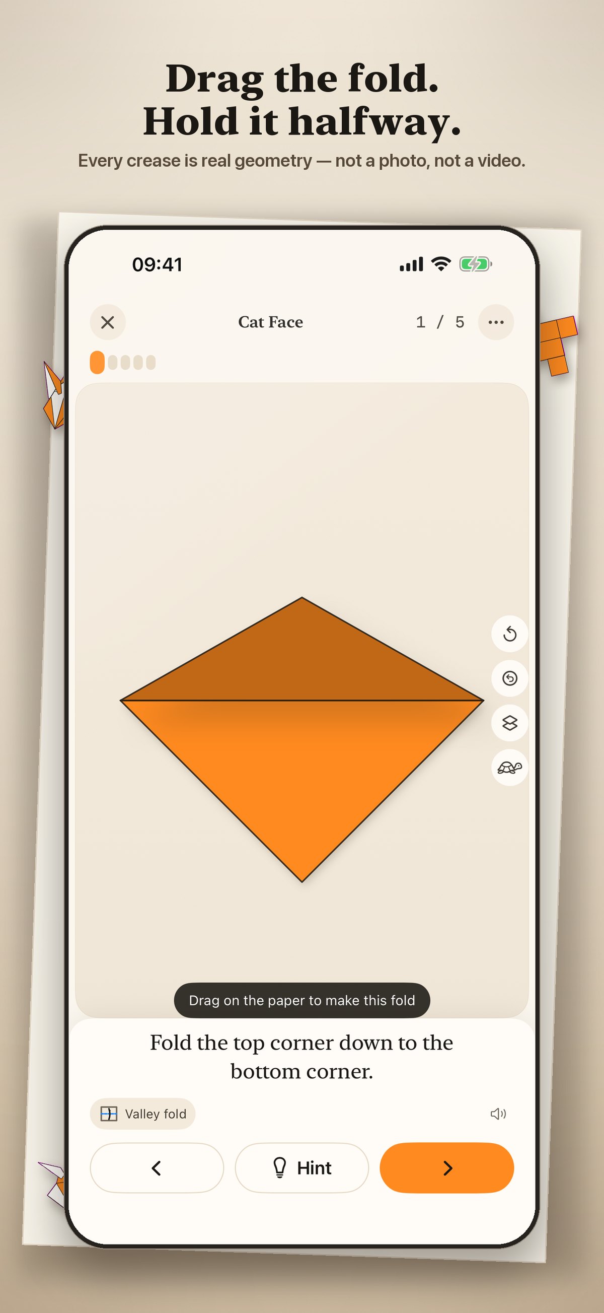 Origami Learn on iPhone, showing a water balloon base mid-fold on a folding desk